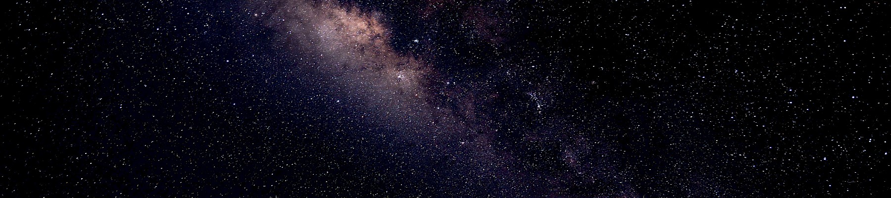 A view of the Milky Way galaxy in the night sky filled with stars and cosmic dust.