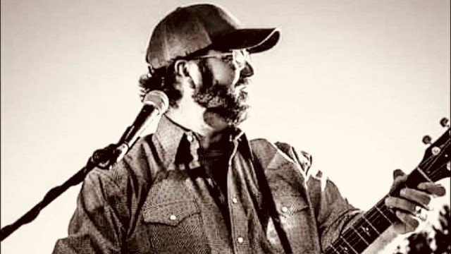 KC Flynn performing acoustic guitar during Beats & Bites Brunch at Riverhouse Lodge in Bend Oregon with guests enjoying brunch.