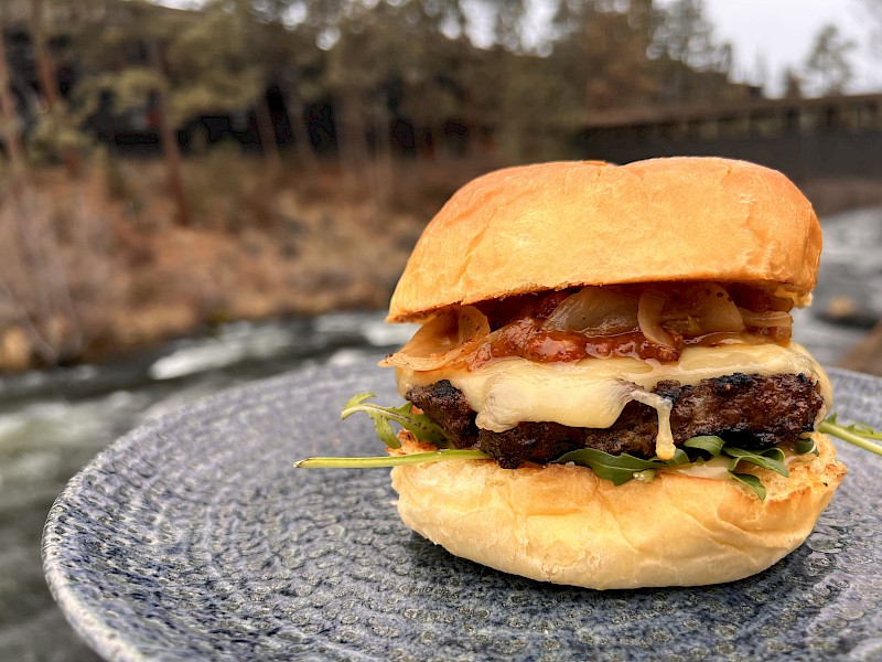 $10 Burger Week special at Currents restaurant Riverhouse Lodge Bend Oregon featuring grilled Oregon beef burger with Gruyère cheese and Mama Lil’s aioli