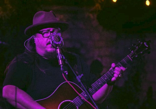 Americana singer songwriter Rudolf Korv performing acoustic guitar live at Currents Restaurant during Live Music Friday at Riverhouse Lodge Bend Oregon.