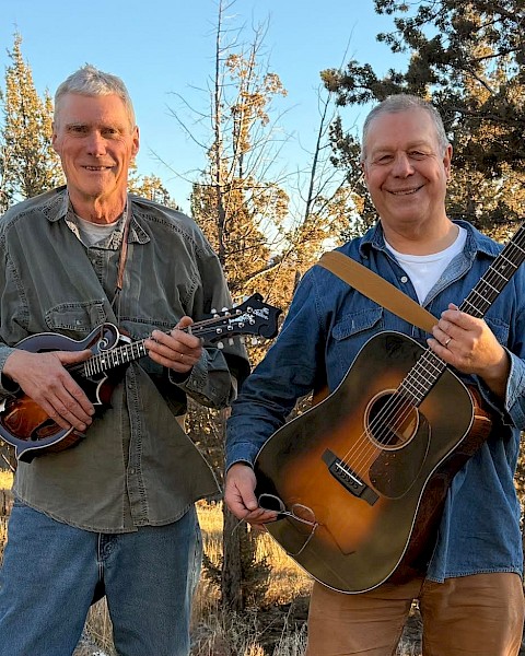 Americana folk musician Mavis Bretz performing acoustic guitar live at Currents Restaurant during Live Music Friday Riverhouse Lodge Bend Oregon.