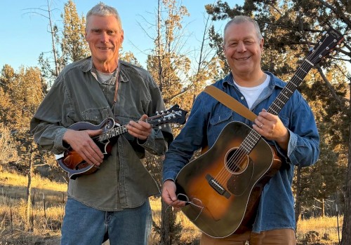 Americana folk musician Mavis Bretz performing acoustic guitar live at Currents Restaurant during Live Music Friday Riverhouse Lodge Bend Oregon.