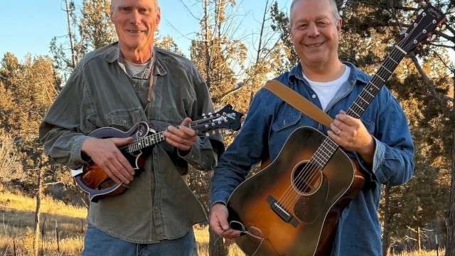 Americana folk musician Mavis Bretz performing acoustic guitar live at Currents Restaurant during Live Music Friday Riverhouse Lodge Bend Oregon.