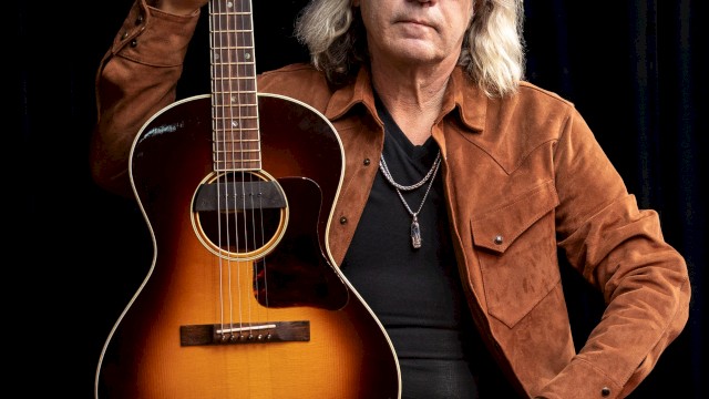 Americana singer songwriter Dean Mueller performing acoustic guitar during Beats and Bites brunch at Riverhouse Lodge Bend Oregon.