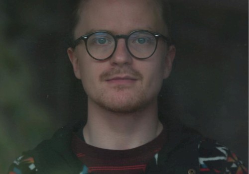 Male musician with glasses performing live acoustic set during brunch inside Currents restaurant in Bend Oregon