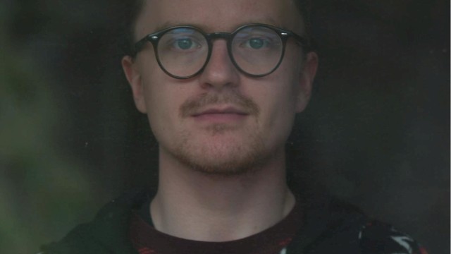 Male musician with glasses performing live acoustic set during brunch inside Currents restaurant in Bend Oregon