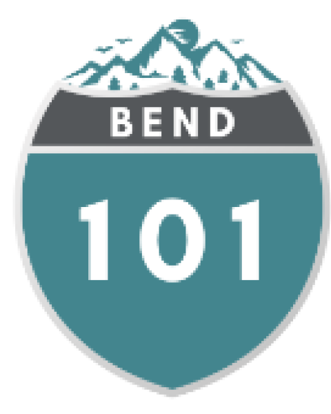 A highway sign for Route 101, the Bend route, showing mountains and a clear sky in the background.