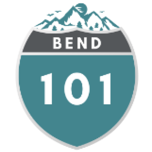 A highway sign for Route 101, the Bend route, showing mountains and a clear sky in the background.
