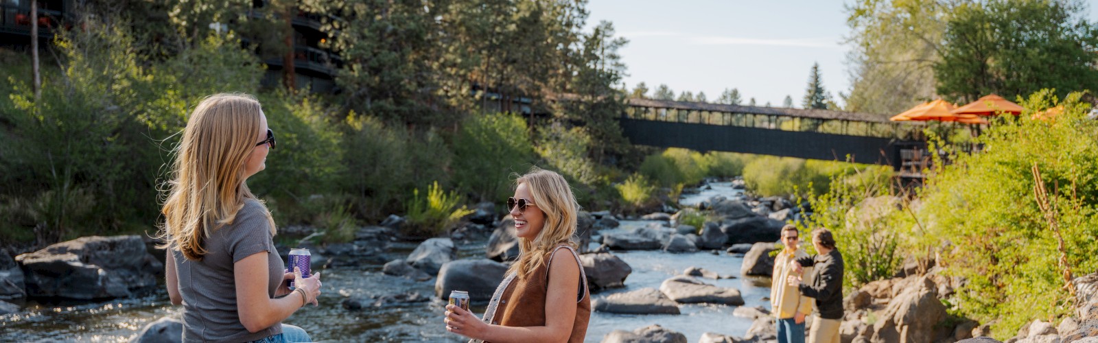 Riverfront hotel in Bend Oregon during Memorial Day weekend with guests enjoying outdoor activities along the Deschutes River at Riverhouse Lodge