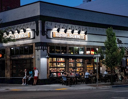 The image shows a busy brewery called 