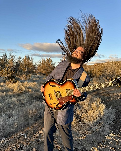 Brogan Woodburn performing live guitar music during Beats & Bites Brunch at Currents Restaurant Bend Oregon