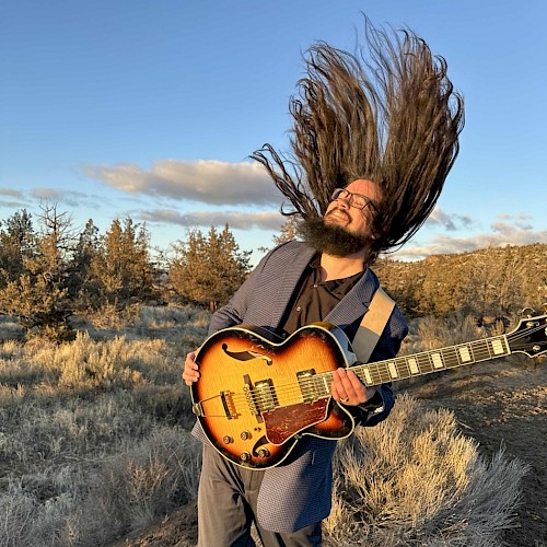 Brogan Woodburn performing live guitar music during Beats & Bites Brunch at Currents Restaurant Bend Oregon