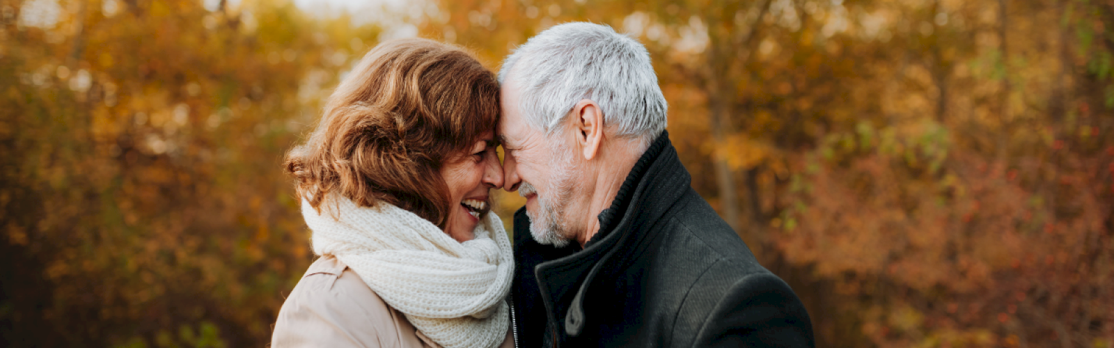 Senior couple touching foreheads in an autumnal setting