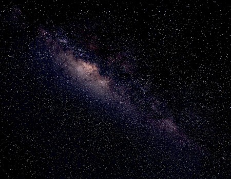 A view of the Milky Way galaxy in the night sky filled with stars and cosmic dust.