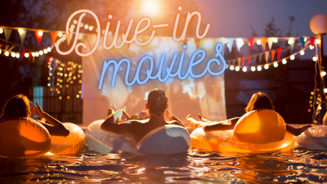 People are watching a movie from the pool with the sign 