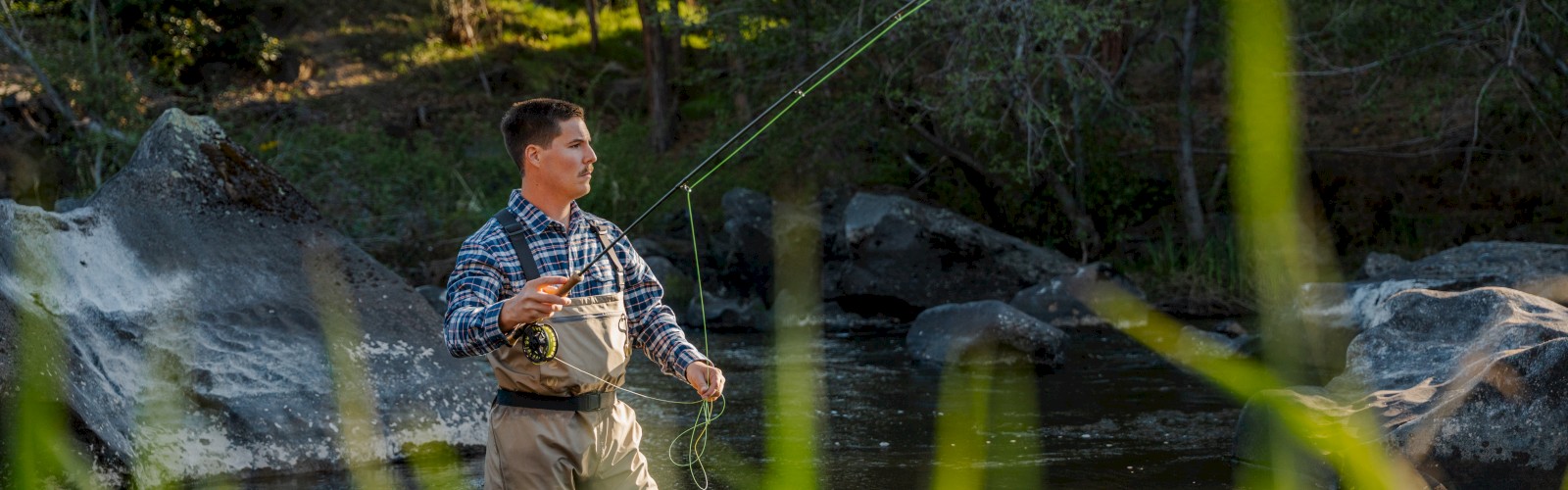 Guest fly fishing in the Deschutes River near Riverhouse Lodge in Bend, Oregon, showcasing riverside access and outdoor adventure steps from this Central Oregon hotel.