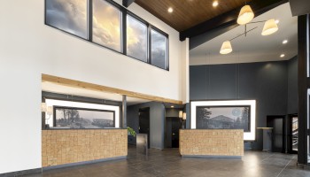 Front desk and lobby interior at Riverhouse Lodge in Bend Oregon featuring modern lodge design, wood ceilings, and welcoming hotel reception area