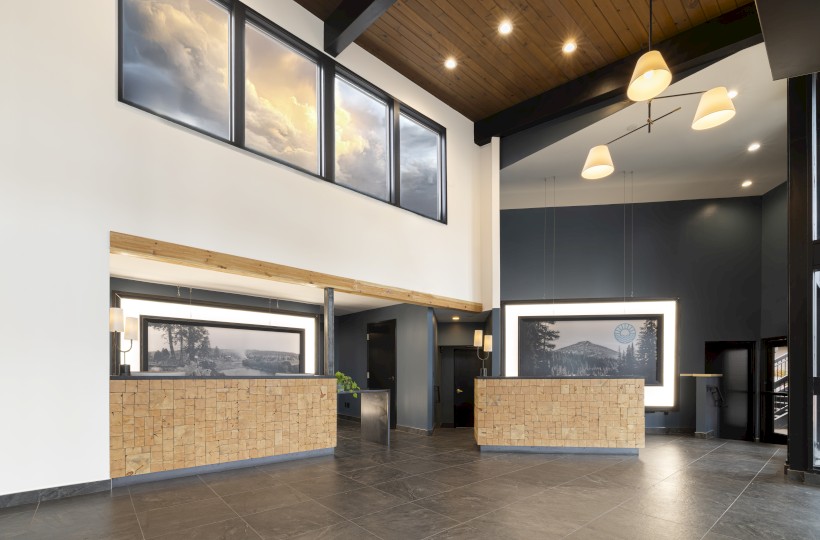Front desk and lobby interior at Riverhouse Lodge in Bend Oregon featuring modern lodge design, wood ceilings, and welcoming hotel reception area