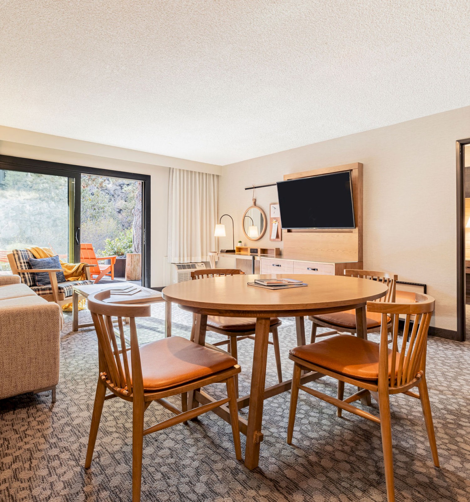 Spacious one-bedroom suite at Riverhouse Lodge in Bend, Oregon featuring a cozy living area, private patio access, and modern amenities for relaxing stays.