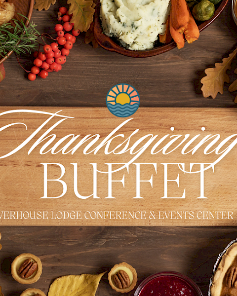 Thanksgiving buffet setup with turkey, salad, pie, fruits, and veggies. Sign reads 