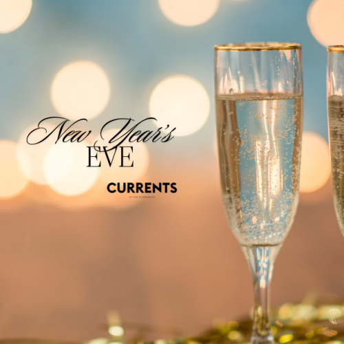 Two champagne flutes with New Year’s Eve text, against a blurred, festive background with bokeh lights.