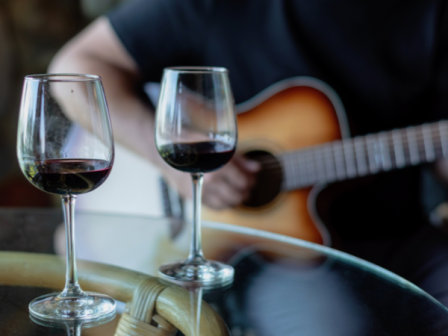 Live acoustic music performance with guitar and percussion at Riverhouse Lodge in Bend, Oregon, creating a lively and energetic riverside atmosphere.