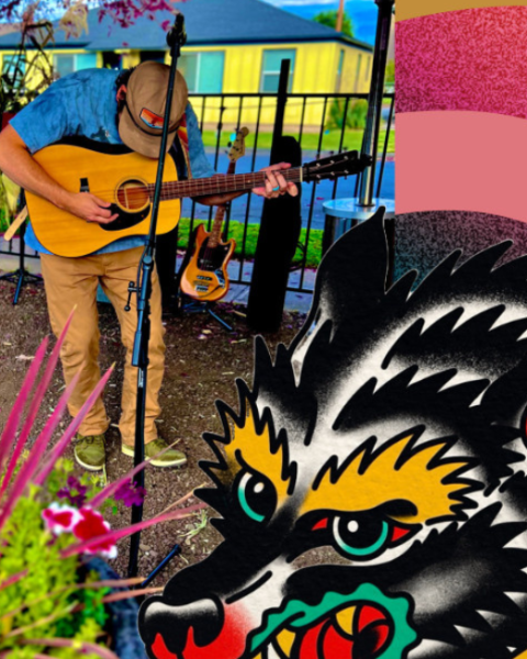 A solo musician plays an acoustic guitar on an outdoor covered patio stage, standing near microphones and sound equipment. Colorful flowers in a planter sit in the foreground, with a decorative wolf illustration and warm, vibrant graphic elements framing the scene.