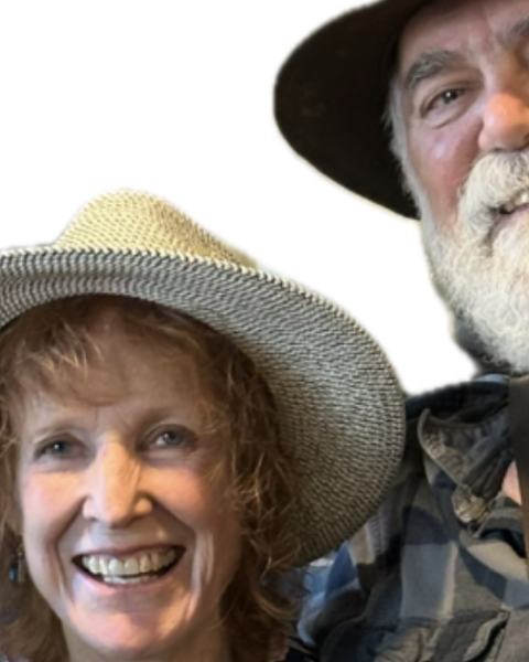 The Dust Devils featuring Maggie Jackson smiling, wearing hats, and standing close together. Live music at Riverhouse Lodge in Bend Oregon 08/07/25