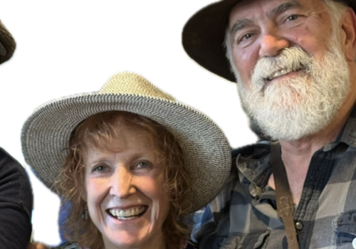 The Dust Devils featuring Maggie Jackson smiling, wearing hats, and standing close together. Live music at Riverhouse Lodge in Bend Oregon 08/07/25