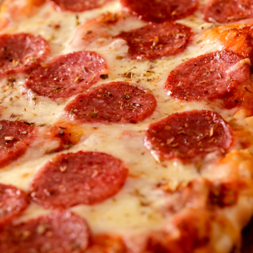 $10 flatbread pizza with pepperoni slices and melted cheese on a wooden board at Currents at Riverhouse in Bend Oregon July 28