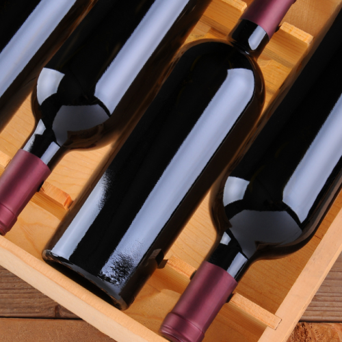 Wine bottles in a wine crate shown for Currents Locals Week with 10% off Wine by the Bottle
