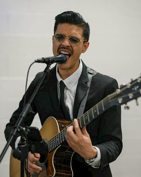 Charlee performing an acoustic R&B set at Currents at Riverhouse Lodge in Bend, Oregon, featuring soulful vocals and guitar.