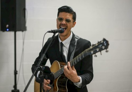 Charlee performing an acoustic R&B set at Currents at Riverhouse Lodge in Bend, Oregon, featuring soulful vocals and guitar.
