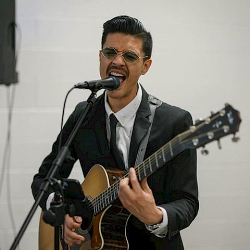 Charlee performing an acoustic R&B set at Currents at Riverhouse Lodge in Bend, Oregon, featuring soulful vocals and guitar.