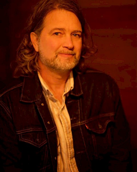 Americana musician John Shipe in a portrait photo, featured live music artist performing at Currents at the Riverhouse in Bend, Oregon.