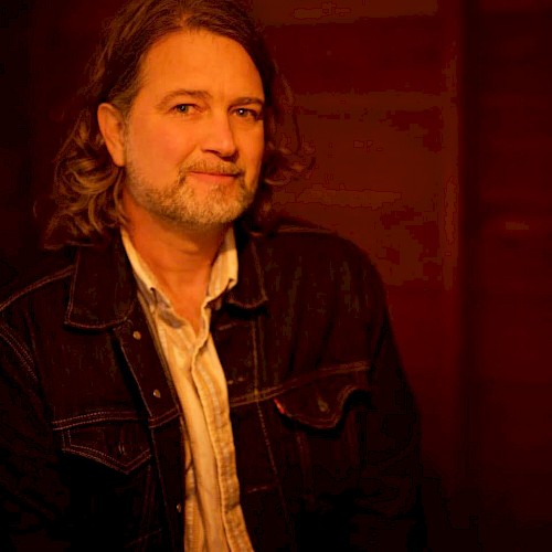 Americana musician John Shipe in a portrait photo, featured live music artist performing at Currents at the Riverhouse in Bend, Oregon.