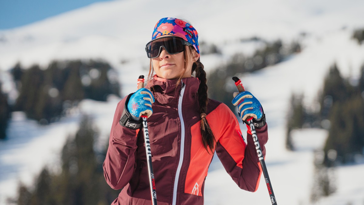 Cross-country skier in winter apparel holding ski poles on a snowy mountain, showcasing Riverhouse Lodge in Bend, Oregon with Kit Lender ski gear delivery for Mt. Bachelor ski vacations and hassle-free mountain travel.
